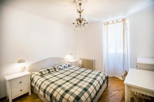 a bedroom with a bed and a chandelier at Casa Caramello in Faggeto Lario 