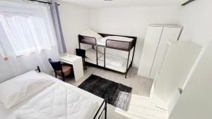 a small bedroom with a bed and a chair at Ferienwohnung Melody in Weisweil