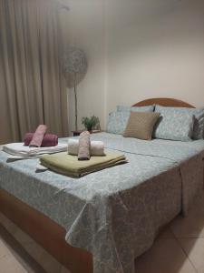 a large bed with two blankets and pillows on it at Ρετρό Κλινάρι in Xanthi