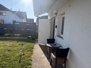a patio with a table and chairs next to a building at Ferienwohnung Melody in Weisweil