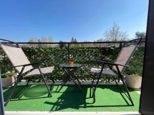 a pair of chairs and a table on a patio at Appartement 3 pièces in Mareil-Marly