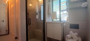 a white bathroom with a shower and a sink at Stylish Cottage with Loft Sleeps 4 in Dublin