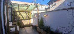an outside view of a building with a pergola at Stylish Cottage with Loft Sleeps 4 in Dublin