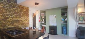 a kitchen with a brick wall and a stove at Stylish Cottage with Loft Sleeps 4 in Dublin