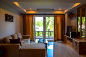 a living room with a couch and a television at Khanom Beach Residence For rent monthly in Khanom