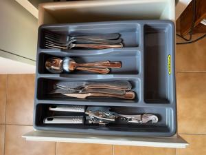 a container filled with utensils in a drawer at Blue Moon Cozy Poolside Bachelor Flat in Bellville