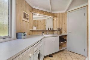 a kitchen with a sink and a washing machine at OH525-Hadsund-Halvrebene-70 in Hadsund +14 photos