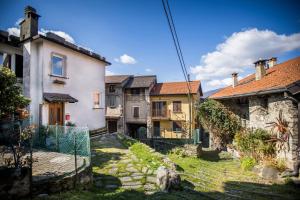 a group of houses in a yard with a fence at Casa Caramello in Faggeto Lario 