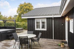 a backyard deck with a table and a piano at OH532-Hadsund-Avaenget-14 in Hadsund