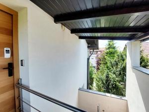 a window in a hallway with a view of trees at GFS way studios - greenline accomodation in Ljubljana +18 photos