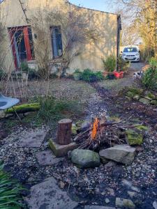 a fire in a yard next to a house at Hilltop Lodge in Cultra