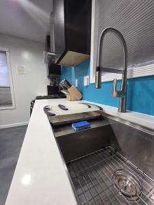 a kitchen with a sink and a counter top at Modern Retro 2BR Condo in High Point