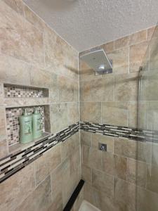 a bathroom with a shower with two green toilets at Modern Retro 2BR Condo in High Point +25 photos