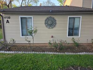 a house with a clock on the side of it at Modern Retro 2BR Condo in High Point