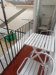 a white bench sitting on a balcony with a staircase at Mediterraneo in Vinarós