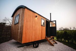 a tiny house sitting on display in a yard at Shepherds View in Ashbourne
