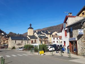 a small town with a church and a street at Au coeur de l'Ariège in Ax-les-Thermes
