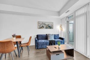 a living room with a blue couch and a table at The York Suites in Toronto