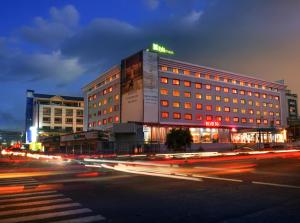 a building on a city street at night at IBIS STYLES KINSHASA in Kinshasa