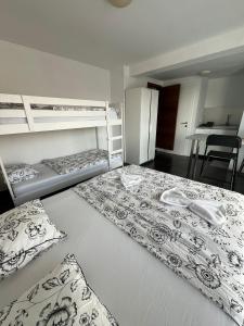 a bedroom with two bunk beds and a kitchen at GFS way studios - greenline accomodation in Ljubljana