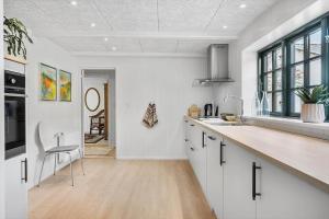 a kitchen with white cabinets and a counter top at 722-Thyboron-Vesterhavsgade-144 in Thyborøn