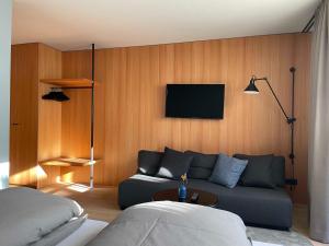a living room with a couch and a flat screen tv at Julius Appartements & Zimmer in Wagrain