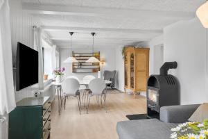 a living room with a table and a fireplace at 722-Thyboron-Vesterhavsgade-144 in Thyborøn