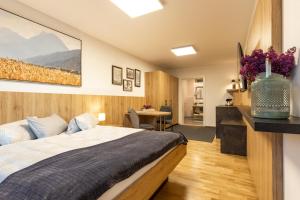 a bedroom with a bed and a desk in a room at Studio Toblaten in Inzing