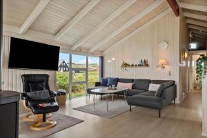 a living room with a couch and a tv at 313-Harboore-Fourmivej-68 in Harboør