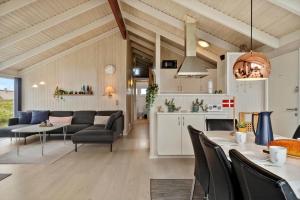a kitchen and living room with a table and chairs at 313-Harboore-Fourmivej-68 in Harboør