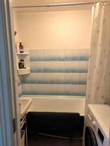 a bathroom with a bath tub and a shower curtain at Central Point Apartments in Rēzekne