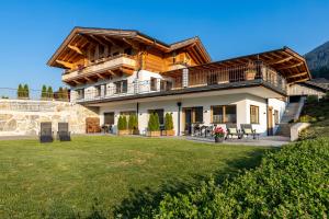 a large house with a large yard in front of it at Studio Toblaten in Inzing