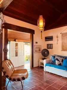 a living room with a couch and a chair at Janaína Picinguaba in Ubatuba