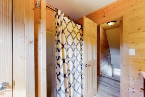 a room with a door with a patterned curtain at Sunshine Days OBX in Nags Head +56 photos