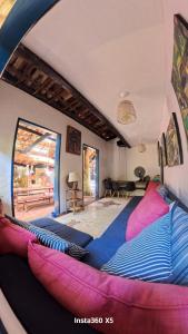 a room with a bed in the middle of it at Janaína Picinguaba in Ubatuba