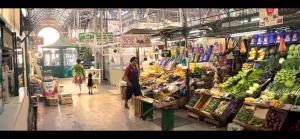 a grocery store with people walking through a market at Lezama Park in Buenos Aires