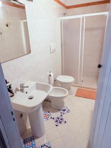 a bathroom with a sink and a toilet at Villa Donna Sibilla in Merine +28 photos