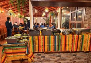 a group of people sitting around a table with books at Hotel Quitus Airport in Quito