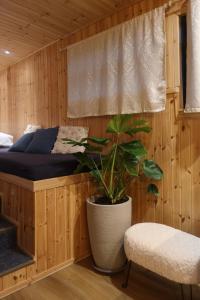 a bedroom with a bed and a potted plant at תחנת גן עדן - Paradise Station in Menaẖemya +30 photos