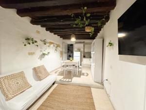 a living room with a white couch and a table at Kalma - at the picturesque Via Stretta in Cagliari