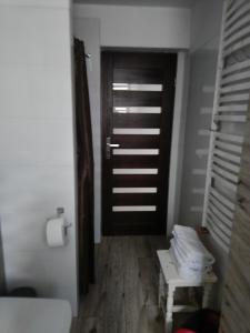a room with a door and a bench in front of it at 3 Rooms Garden Parking in Raszyn