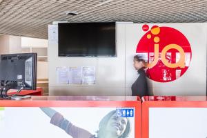 a person standing behind a counter with their arm up at HI Aveiro – Pousada de Juventude in Aveiro