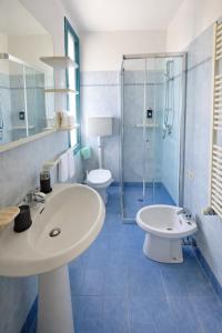 a bathroom with a sink and a toilet and a shower at Bellariva appartamenti in Rimini +59 photos