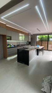 a large kitchen with a large island in the middle at Mini Palacete in Ribeirão Preto