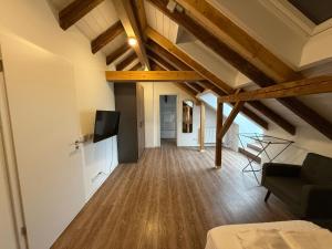 a living room with a couch and a tv at TRUST Boardinghouse in Stuttgart