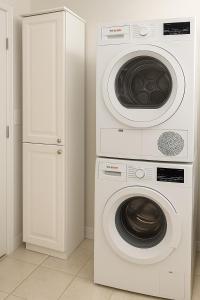 two washing machines and a washer and dryer in a room at Suite and Simple in Ucluelet