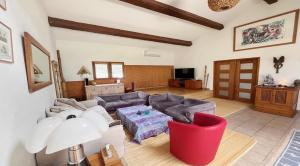 a living room with a couch and a table at Villa au calme sans vis à vis in Fayence