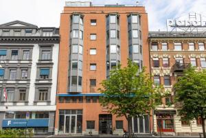 a tall brick building on a city street at Apartment Aker brygge- Oslo sentrum in Oslo +9 photos