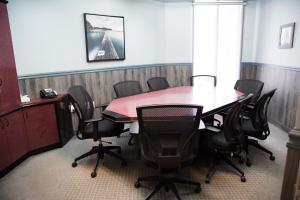 a conference room with a table and chairs at Auberge l'Ambassadeur in Amqui +33 photos