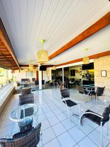 a patio with chairs and tables on a building at Pousada São Silmares in Fernando de Noronha